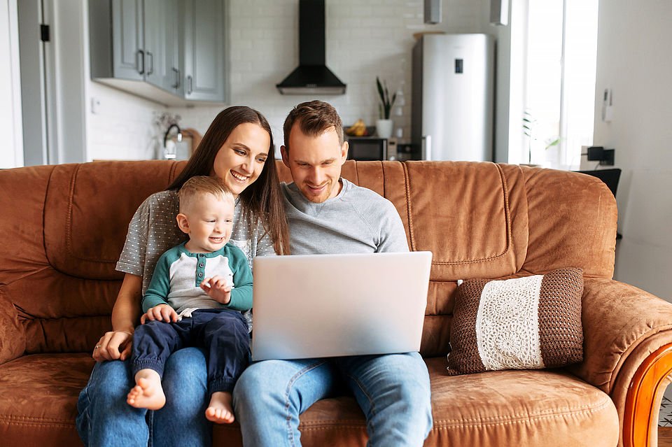 A young family communicating via video with family